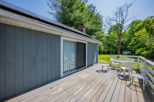 824 Torringford W St, Torrington, CT 06790 - deck featuring outdoor dining space, view of scattered trees, and a yard