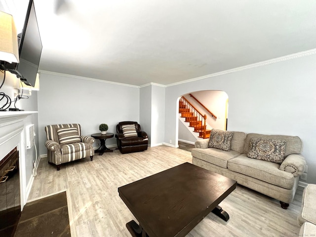 17 Rock Spring Rd, Stamford, CT 06906 - living room with arched walkways, wood finished floors, crown molding, stairway, and a fireplace