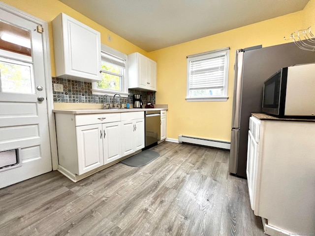 17 Rock Spring Rd, Stamford, CT 06906 - kitchen featuring baseboard heating, stainless steel dishwasher, black microwave, and light wood-style floors