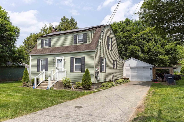 12 John St, Killingly, CT 06239 - dutch colonial featuring an outdoor structure, a chimney, a gambrel roof, a front yard, and roof with shingles