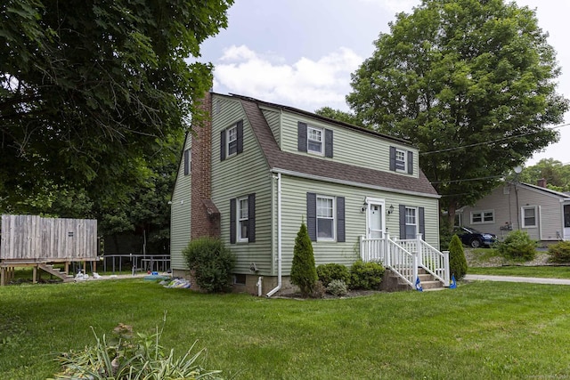 12 John St, Killingly, CT 06239 - colonial inspired home featuring a front lawn, roof with shingles, and a gambrel roof