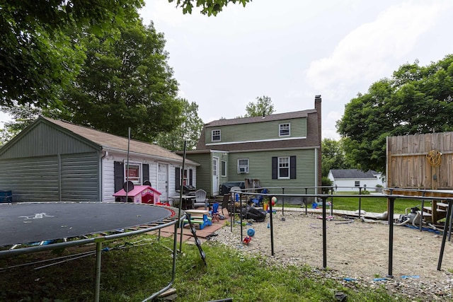 12 John St, Killingly, CT 06239 - back of property with a trampoline, a chimney, and a shingled roof