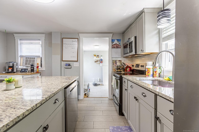 12 John St, Killingly, CT 06239 - kitchen featuring stainless steel appliances, a sink, light stone countertops, cooling unit, and hanging light fixtures