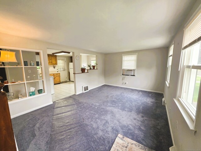 149 Branford St, Manchester, CT 06040 - unfurnished living room with light carpet, cooling unit, baseboards, and light tile patterned flooring