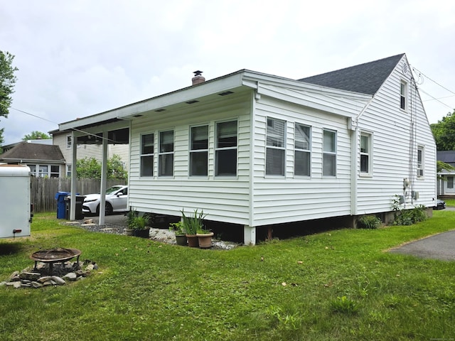 149 Branford St, Manchester, CT 06040 - view of side of property with a fire pit, a chimney, and a shingled roof