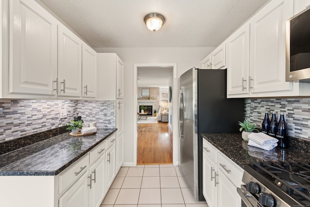 75 Brittania Rd Unit 75, Danbury, CT 06811 - kitchen with stainless steel appliances, white cabinets, backsplash, and a textured ceiling
