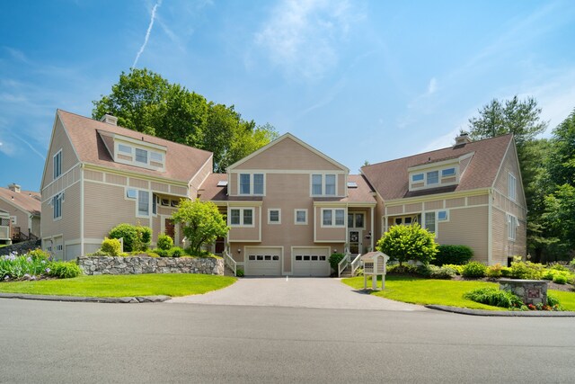 75 Brittania Rd Unit 75, Danbury, CT 06811 - view of front facade with an attached garage, concrete driveway, a chimney, and a front lawn