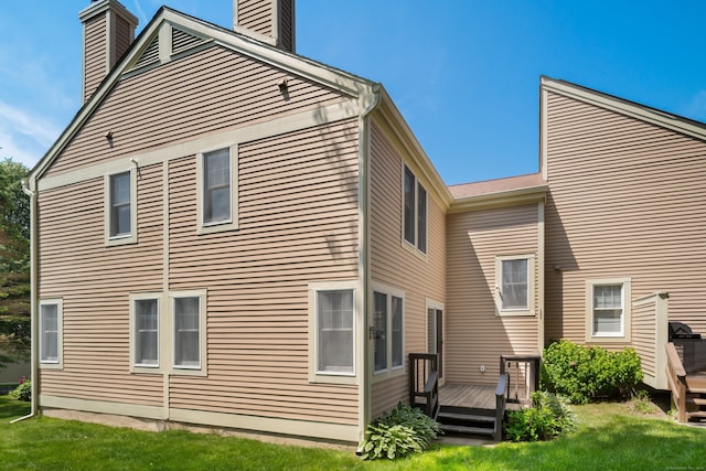 75 Brittania Rd Unit 75, Danbury, CT 06811 - rear view of house featuring a chimney, a wooden deck, and a lawn
