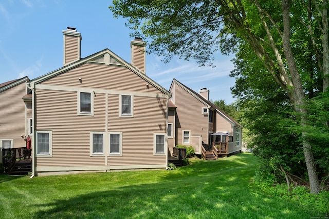 75 Brittania Rd Unit 75, Danbury, CT 06811 - back of house featuring a deck, a yard, and a chimney