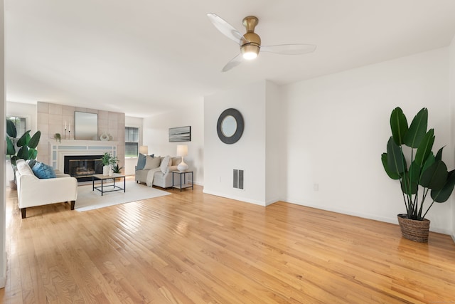 75 Brittania Rd Unit 75, Danbury, CT 06811 - unfurnished living room featuring light wood finished floors, ceiling fan, a glass covered fireplace, and baseboards