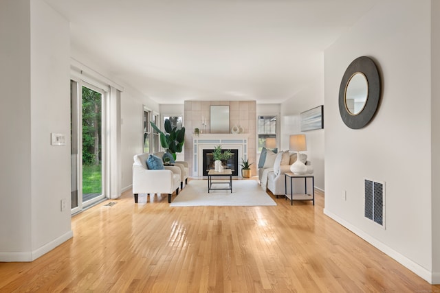 75 Brittania Rd Unit 75, Danbury, CT 06811 - unfurnished living room featuring light wood-type flooring, baseboards, and a fireplace with raised hearth