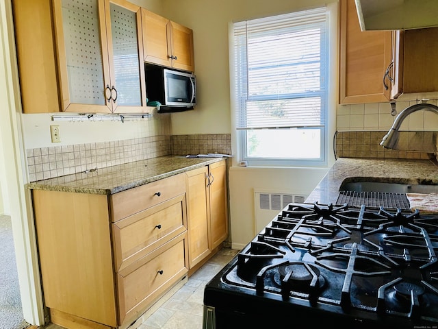 264 Glenbrook Rd Unit D, Stamford, CT 06906 - kitchen with stainless steel microwave, backsplash, a sink, range, and light stone counters