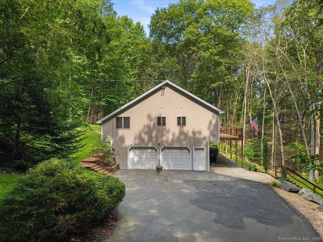 2 Round Hill Rd, Shelton, CT 06484 - view of property exterior with a garage, a deck, driveway, and a forest view