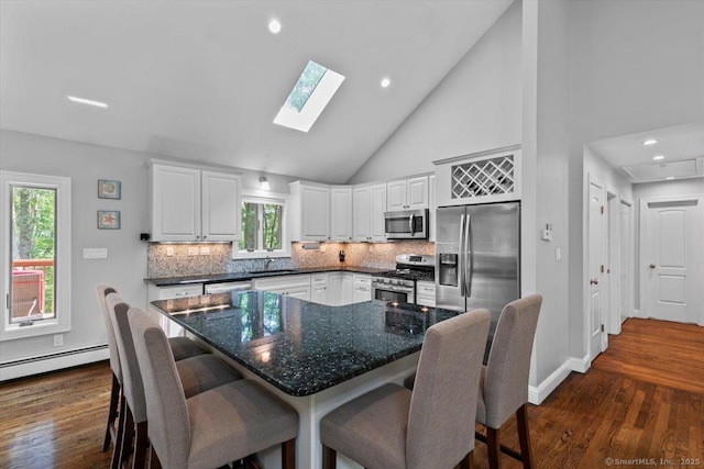 2 Round Hill Rd, Shelton, CT 06484 - kitchen featuring appliances with stainless steel finishes, tasteful backsplash, plenty of natural light, white cabinetry, and high vaulted ceiling