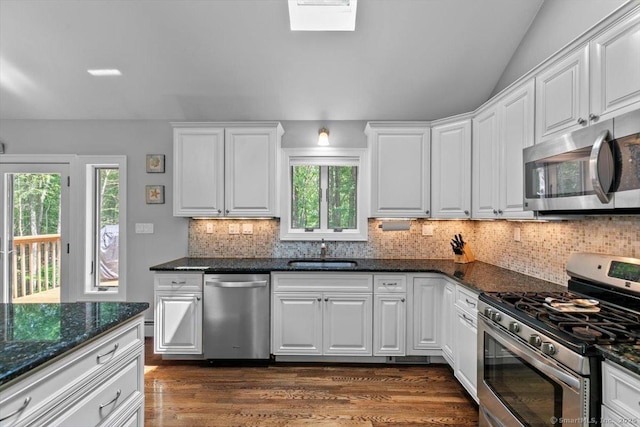 2 Round Hill Rd, Shelton, CT 06484 - kitchen with appliances with stainless steel finishes, white cabinets, tasteful backsplash, dark wood-type flooring, and dark stone countertops