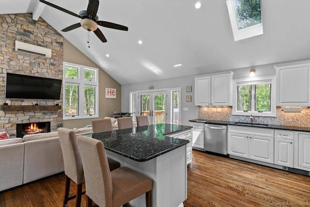 2 Round Hill Rd, Shelton, CT 06484 - kitchen with dishwasher, open floor plan, an AC wall unit, a kitchen island, and wood finished floors