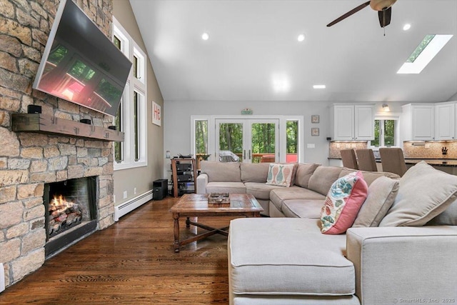 2 Round Hill Rd, Shelton, CT 06484 - living area with a baseboard radiator, a ceiling fan, dark wood-style floors, a stone fireplace, and a skylight
