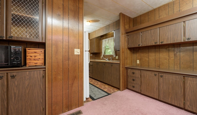 126 Christain Hill Rd, Dover, NY 12522 - kitchen with light carpet, wood walls, and brown cabinets