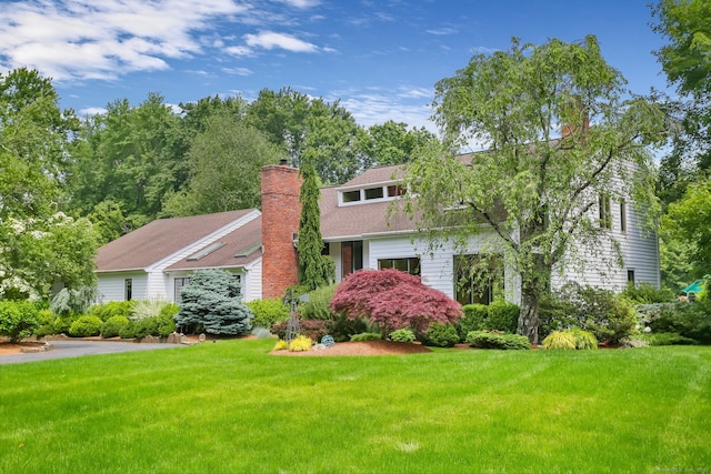 8 Hedgerow Cmn, Weston, CT 06883 - view of front facade with a chimney and a front lawn