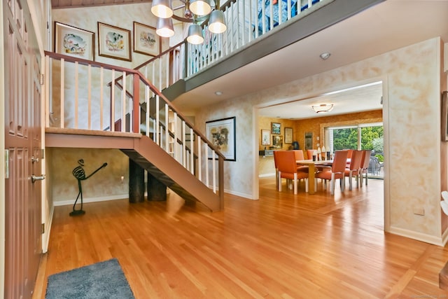 8 Hedgerow Cmn, Weston, CT 06883 - stairs featuring baseboards, wood finished floors, and a chandelier