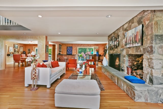 8 Hedgerow Cmn, Weston, CT 06883 - living room with wood finished floors, a stone fireplace, and recessed lighting