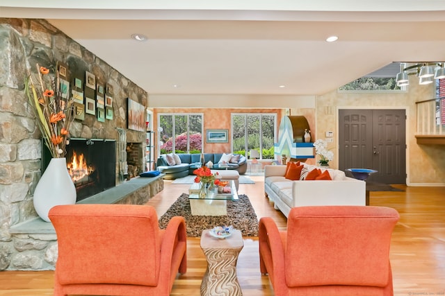 8 Hedgerow Cmn, Weston, CT 06883 - living room featuring a stone fireplace, wood finished floors, and baseboards