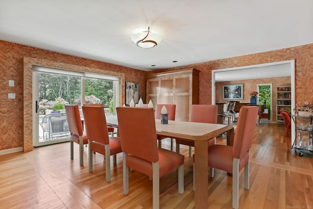 8 Hedgerow Cmn, Weston, CT 06883 - dining room featuring wallpapered walls, light wood-style floors, and baseboards