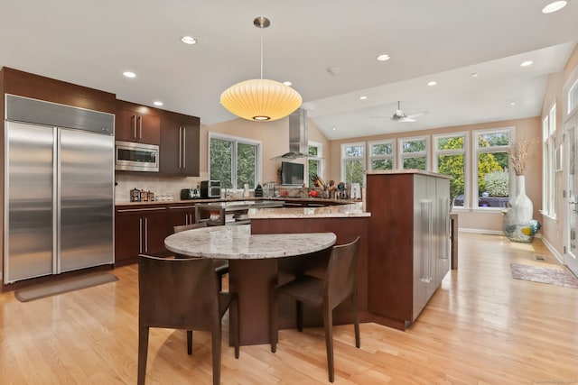 8 Hedgerow Cmn, Weston, CT 06883 - kitchen with built in appliances, light wood finished floors, healthy amount of natural light, recessed lighting, and vaulted ceiling