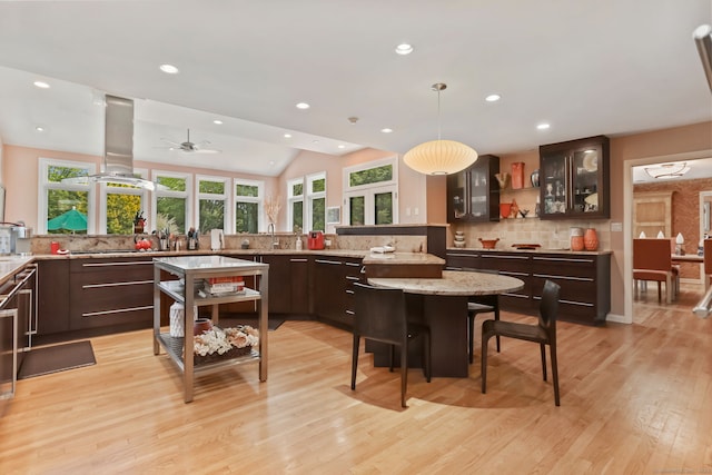 8 Hedgerow Cmn, Weston, CT 06883 - kitchen with dark brown cabinetry, tasteful backsplash, plenty of natural light, recessed lighting, and glass insert cabinets