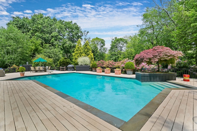 8 Hedgerow Cmn, Weston, CT 06883 - view of swimming pool featuring a wooden deck, view of scattered trees, and area for grilling