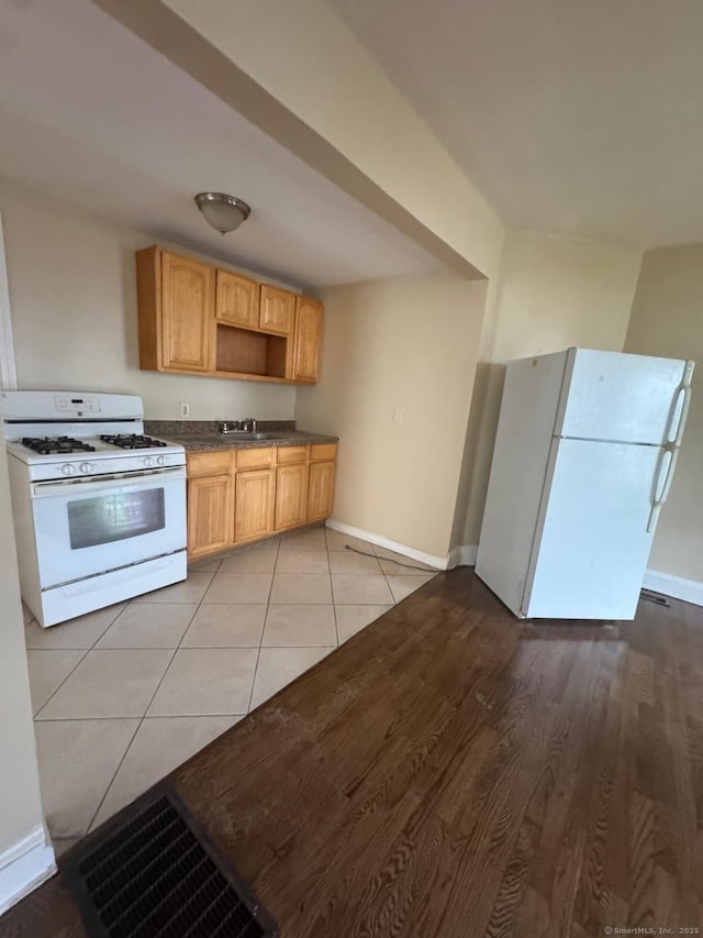 49 Dover St, Bridgeport, CT 06610 - kitchen with white appliances, dark countertops, light wood finished floors, and open shelves
