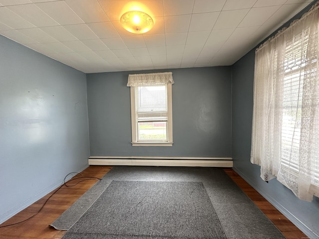189 N Main St, Griswold, CT 06351 - spare room featuring wood finished floors, a baseboard radiator, and baseboards