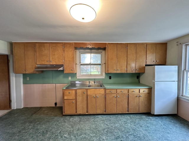 189 N Main St, Griswold, CT 06351 - kitchen with freestanding refrigerator, brown cabinets, under cabinet range hood, and healthy amount of natural light