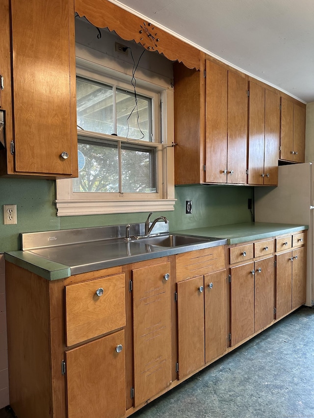 189 N Main St, Griswold, CT 06351 - kitchen featuring a sink, brown cabinetry, and freestanding refrigerator