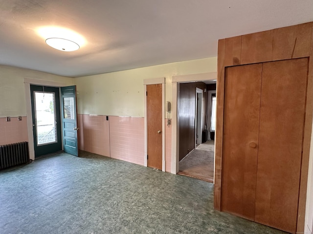 189 N Main St, Griswold, CT 06351 - empty room featuring radiator, tile walls, and wainscoting