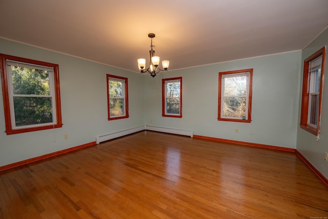 65 Spring St, Middlefield, CT 06481 - empty room featuring a chandelier, wood finished floors, healthy amount of natural light, crown molding, and baseboards
