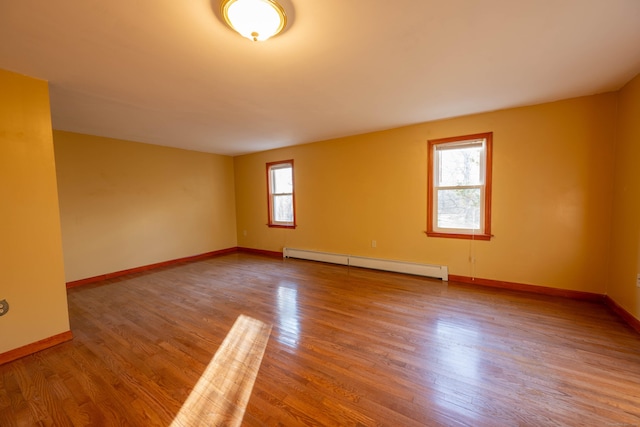 65 Spring St, Middlefield, CT 06481 - unfurnished room featuring a baseboard heating unit, wood finished floors, and baseboards