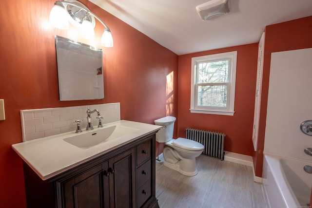 65 Spring St, Middlefield, CT 06481 - bathroom featuring radiator heating unit, toilet, vanity, baseboards, and lofted ceiling