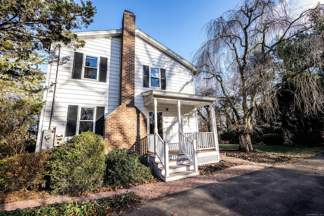 65 Spring St, Middlefield, CT 06481 - view of front of home featuring a chimney, a porch, and brick siding