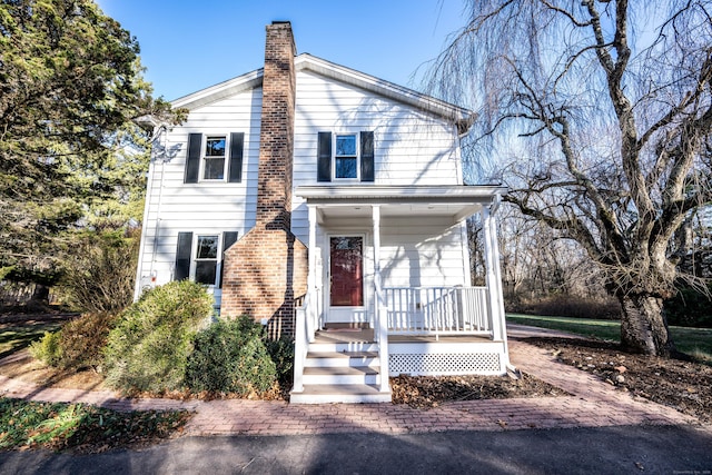 65 Spring St, Middlefield, CT 06481 - view of front facade featuring a chimney and covered porch