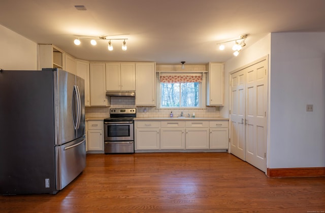65 Spring St, Middlefield, CT 06481 - kitchen featuring appliances with stainless steel finishes, decorative backsplash, white cabinets, and under cabinet range hood