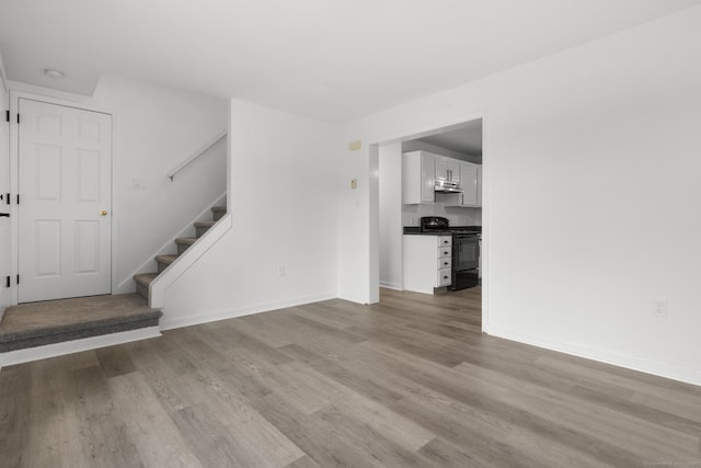 59 Colony St, Bristol, CT 06010 - unfurnished living room with wood finished floors and stairs