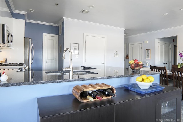 4 Daskams Ln Unit 303, Norwalk, CT 06851 - kitchen with stainless steel appliances, ornamental molding, dark stone counters, and a peninsula