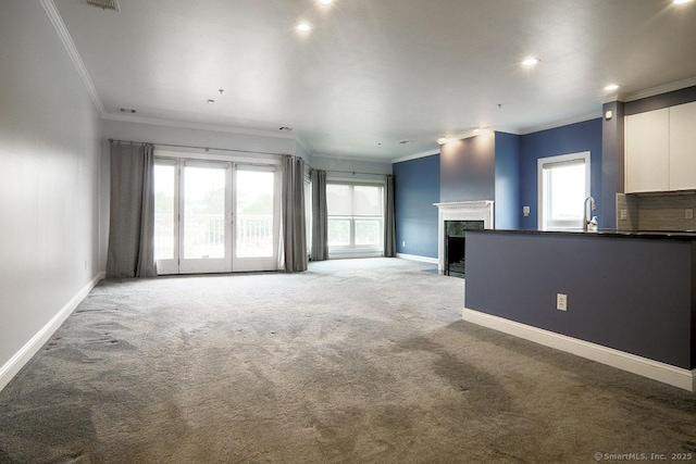 4 Daskams Ln Unit 303, Norwalk, CT 06851 - unfurnished living room with ornamental molding, carpet flooring, a high end fireplace, healthy amount of natural light, and recessed lighting