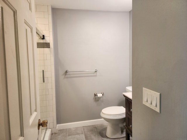 2415 Shepard Ave Apt 30, Hamden, CT 06518 - bathroom with vanity, toilet, a tile shower, tile patterned flooring, and baseboards
