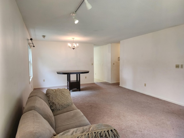 2415 Shepard Ave Apt 30, Hamden, CT 06518 - carpeted living room featuring a chandelier, rail lighting, and baseboards