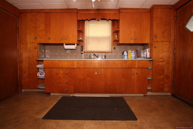 87 Hayden St, Windham, CT 06226 - kitchen featuring open shelves, a drop ceiling, tasteful backsplash, brown cabinets, and light tile patterned floors