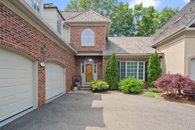 184 Stillson Rd Unit 184, Fairfield, CT 06825 - property entrance with brick siding, driveway, and a garage