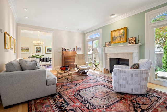 184 Stillson Rd Unit 184, Fairfield, CT 06825 - living room featuring a chandelier, crown molding, a fireplace, wood finished floors, and baseboards