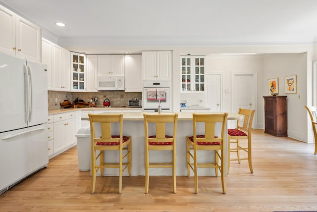 184 Stillson Rd Unit 184, Fairfield, CT 06825 - kitchen featuring white appliances, light wood-style floors, backsplash, light countertops, and crown molding